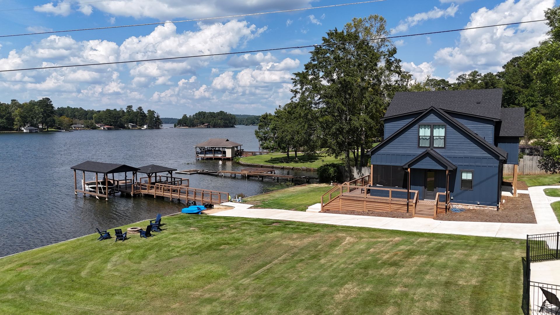 Aerial view of the house, lawn, dock, and kayaks